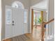 Bright foyer with hardwood floors, transom window, and view to living spaces at 12303 Shadow Ridge Ln, Charlotte, NC 28273