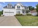 Charming two-story home with well-maintained lawn, neat landscaping, and welcoming front porch at 12303 Shadow Ridge Ln, Charlotte, NC 28273