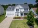 Charming two-story home with well-maintained lawn, neat landscaping, and covered front porch at 12303 Shadow Ridge Ln, Charlotte, NC 28273