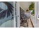 Cozy porch with rocking chairs, decorative greenery, and a welcoming entryway at 12303 Shadow Ridge Ln, Charlotte, NC 28273