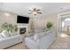 Comfortable living room features a fireplace, tv, furniture seating, and access to the front door at 12303 Shadow Ridge Ln, Charlotte, NC 28273