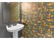 Charming powder room featuring tiger-themed wallpaper, a pedestal sink, and a decorative gold shelf at 12303 Shadow Ridge Ln, Charlotte, NC 28273