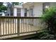 Close up view of a new wooden backyard deck with safety railings and sun-drenched planks at 1250 Hampton Grace Ave, Lancaster, SC 29720