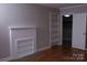 Stylish bedroom featuring a white brick fireplace, built-in shelving, and hardwood floors at 1250 Hampton Grace Ave, Lancaster, SC 29720