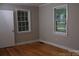 Cozy bedroom features hardwood floors, two windows, and a door at 1250 Hampton Grace Ave, Lancaster, SC 29720