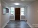 Inviting entryway with modern gray flooring and a solid wood front door for a warm welcome at 1250 Hampton Grace Ave, Lancaster, SC 29720