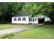 Charming single-story home with white siding, black shutters, and an attached one-car carport at 1250 Hampton Grace Ave, Lancaster, SC 29720