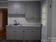 Stylish kitchen showcasing grey cabinets, white countertops, and a stainless steel sink at 1250 Hampton Grace Ave, Lancaster, SC 29720
