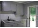 Well-lit kitchen boasts grey cabinets, white countertops, and modern fixtures at 1250 Hampton Grace Ave, Lancaster, SC 29720