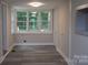 Bright laundry room features large windows and sleek gray flooring at 1250 Hampton Grace Ave, Lancaster, SC 29720