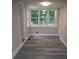 Bright laundry room features large windows and sleek gray flooring at 1250 Hampton Grace Ave, Lancaster, SC 29720