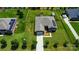 Aerial view of a home featuring a well-maintained lawn and solar panels, with a long driveway at 141 Tall Fern Loop, Mooresville, NC 28117