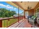 Spacious covered back porch, perfect for enjoying the outdoors with serene views of the large backyard at 141 Tall Fern Loop, Mooresville, NC 28117