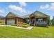 Beautiful brick home with landscaped yard and cozy front porch, creating a welcoming atmosphere at 141 Tall Fern Loop, Mooresville, NC 28117