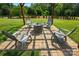 Patio with fire pit under a pergola; perfect outdoor gathering spot for relaxing and entertaining at 141 Tall Fern Loop, Mooresville, NC 28117