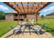 Backyard patio with a fire pit and pergola; designed for cozy outdoor gatherings and relaxation at 141 Tall Fern Loop, Mooresville, NC 28117