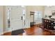 Welcoming foyer with wood floors, ample natural light, and an elegant coat rack and shoe rack at 141 Tall Fern Loop, Mooresville, NC 28117