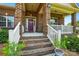 Charming front entrance featuring brick stairs and a lovely porch, curb appeal at its finest at 141 Tall Fern Loop, Mooresville, NC 28117