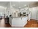 Bright kitchen with granite countertops, stainless appliances, and modern white cabinets at 141 Tall Fern Loop, Mooresville, NC 28117