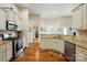 Updated kitchen with stainless appliances, granite countertops, and hardwood floors at 141 Tall Fern Loop, Mooresville, NC 28117