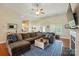 Comfortable living room features hardwood floors, a ceiling fan, and cozy sectional seating at 141 Tall Fern Loop, Mooresville, NC 28117