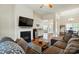 Inviting living room featuring a fireplace, modern decor, and open concept design with hardwoods at 141 Tall Fern Loop, Mooresville, NC 28117