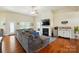 Spacious living room with a fireplace, large TV, and a cozy seating area with hardwoods at 141 Tall Fern Loop, Mooresville, NC 28117