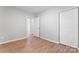 Bedroom featuring wood-look flooring, a closet, and an open doorway at 146 Georgia Sw St, Concord, NC 28025