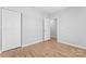 Neat bedroom featuring wood-look floors, a closet, and neutral paint at 146 Georgia Sw St, Concord, NC 28025