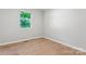 Bright bedroom featuring hardwood floors and a window with natural light at 146 Georgia Sw St, Concord, NC 28025