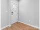 Bright entryway with a white paneled front door, wood-look flooring, and neutral walls at 146 Georgia Sw St, Concord, NC 28025