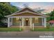 Charming single-story home with a covered front porch, neutral siding and manicured lawn at 146 Georgia Sw St, Concord, NC 28025