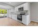 Modern kitchen featuring stainless steel appliances, granite countertops, and white cabinetry at 146 Georgia Sw St, Concord, NC 28025