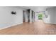 Spacious living area with wood-look flooring, spiral staircase, and access to a balcony at 146 Georgia Sw St, Concord, NC 28025