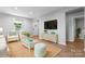 Bright living room with light wood floors, neutral colors, and a view of the front entry at 146 Georgia Sw St, Concord, NC 28025