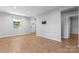 Open living room features wood-look floors and neutral walls at 146 Georgia Sw St, Concord, NC 28025