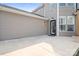 The patio area features a tan exterior, an entrance door and string lights overhead at 14923 Almondell Dr, Huntersville, NC 28078