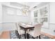 Bright dining room with modern chandelier, wooden table, and neutral tones, perfect for Gathering gatherings at 14923 Almondell Dr, Huntersville, NC 28078