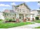 Charming two-story home featuring a welcoming front porch, lush landscaping, and classic architectural details at 14923 Almondell Dr, Huntersville, NC 28078