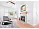 Cozy living room features a fireplace, wood floors, and plenty of natural light at 14923 Almondell Dr, Huntersville, NC 28078