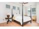 Serene main bedroom with four-poster bed, soft lighting, and a peaceful ambiance for relaxation at 14923 Almondell Dr, Huntersville, NC 28078