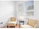 Comfortable sitting area with patterned chairs, natural light, and modern design, creating a cozy retreat at 14923 Almondell Dr, Huntersville, NC 28078