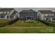 Aerial view of backyard with lawn and a covered patio at 15216 Shallow Ridge Rd, Charlotte, NC 28278