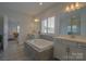Bright bathroom with soaking tub, double vanity, walk-in shower and view of other rooms at 15216 Shallow Ridge Rd, Charlotte, NC 28278