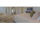 Bedroom with neutral decor with a view to an adjoining room plus a gold mirror and plush carpeting at 15216 Shallow Ridge Rd, Charlotte, NC 28278