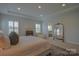 Spacious bedroom boasts with natural light, a large gold mirror, and plush carpeting at 15216 Shallow Ridge Rd, Charlotte, NC 28278