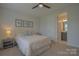 Cozy bedroom with a queen bed, neutral decor, and an ensuite bathroom, creating a relaxing retreat at 15216 Shallow Ridge Rd, Charlotte, NC 28278