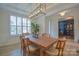 Elegant dining room with modern light fixture and a view into the living room at 15216 Shallow Ridge Rd, Charlotte, NC 28278