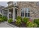 Inviting front porch with stone accents and well-maintained landscaping at 15216 Shallow Ridge Rd, Charlotte, NC 28278