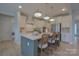 Spacious kitchen island with bar seating, stainless steel appliances, and ample cabinet space, perfect for entertaining at 15216 Shallow Ridge Rd, Charlotte, NC 28278